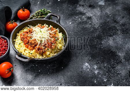 Bolognese Pasta, Risone With Ground Beef In A Plate. Black Background. Top View. Copy Space