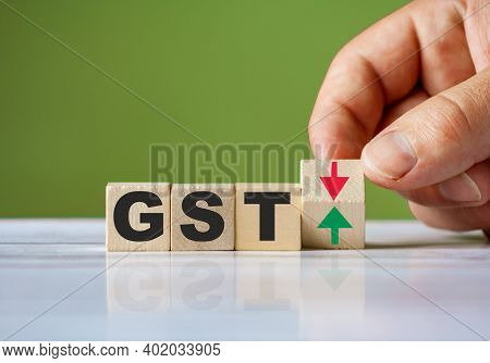 The Hand Turn Wooden Block With Red And Green Arrow As Change Concept Of Gst. Word Gst Conceptual Sy