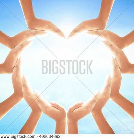 World Health Day Concept: Human Hands In Shape Of Heart On Blurred Sun Light And Blue Sky With Ocean