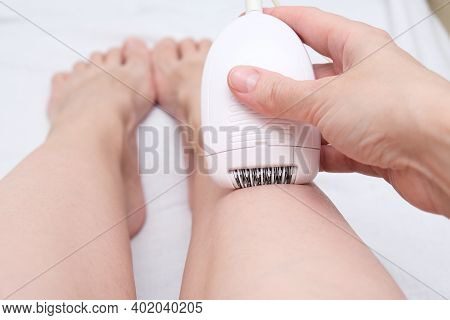 Unwanted Extra Hair Removal, Woman Epilating, Depilating Legs With An Electric Epilator Close Up, Ho