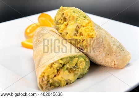 Jack Cheese Burrito With Roasted Green Chilli, Cut In Half And Stacked On A Plate To Eat.