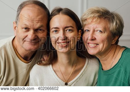 Close Up Portrait Of Family With Elderly Mature Woman, Man And Millennial Daughter