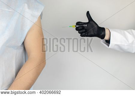 Infectious Disease Doctor Gives The Patient A Medical Vaccination In The Shoulder. Immunization Agai
