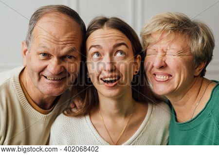 Close Up Portrait Of Family With Elderly Mature Woman, Man And Millennial Daughter