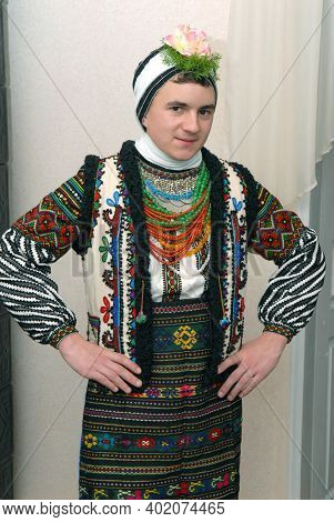 Goroshova, Ternopil Oblast, Ukraine - 14.01.2013: Young man is dressed up in Malanka costume. Malanka celebration in Goroshova village.