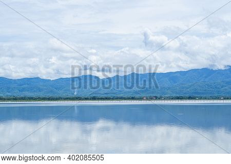 Naga Statue Or Phayanak With A Bright Sky, Clouds, Mountains Background And Freshwater Lake (kwan Ph