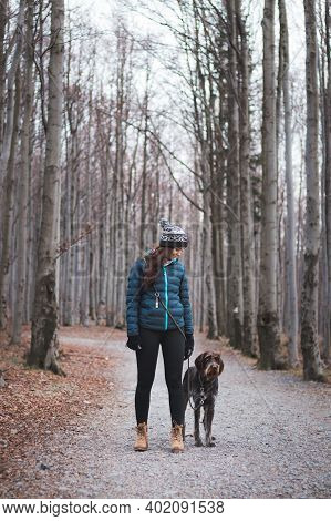 Young Lady With Her Dog In Beautiful Forest On A Morning Walk. Connection Between A Dog And Woman. R