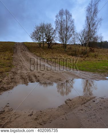 A Muddy Puddle And A Dirt Road At A Moor. Picture From Revingehed, Scania County, Sweden