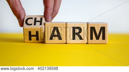 From Harm To Charm. Male Hand Turns The Cube And Changes Word 'harm' To 'charm'. Beautiful Yellow Ta