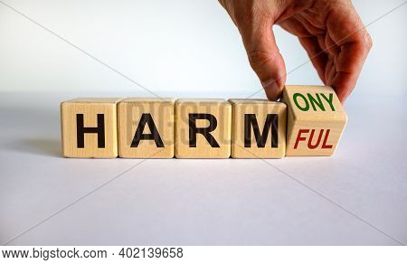 From Harmful To Harmony. Male Hand Turns The Cube And Changes The Word 'harmful' To 'harmony'. Beaut