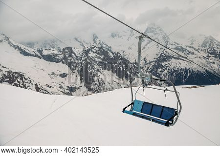 Ski Chair Lift Ropeway At The Ski Resort, View From The Funicular To The Mountains