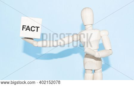 Business And Design Concept - Wooden Mannequin With Surreal Wood Cube Fact. The Symbol Of Leadership