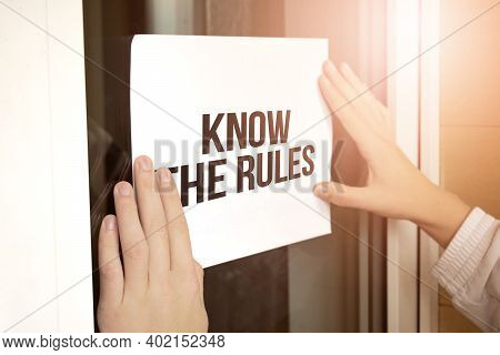 Closeup Of Owner Holding Text Know The Rules In Store