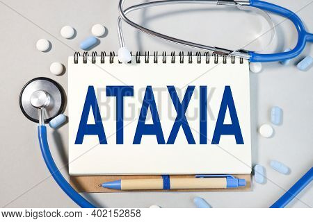 Ataxia, Text On White Notepad Paper Near Medical Supplies. Medicine Concept