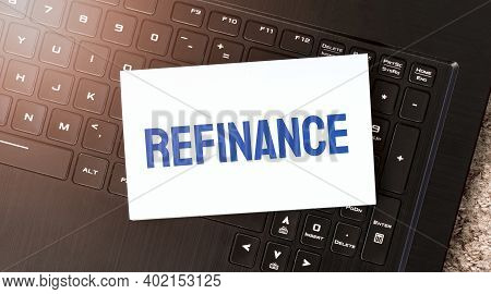 White Paper Sheet With Text Refinance On The Black Laptop