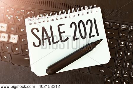 White Paper Sheet With Text Sale 2021 On The Black Laptop