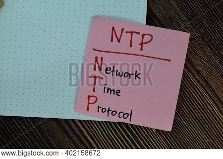 Ntp - Network Time Protocol Write On Sticky Notes Isolated On Wooden Table.