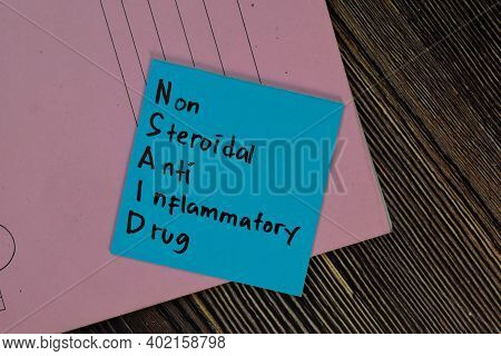 Nsaid - Non Steroidal Anti Inflammatory Drug Write On Sticky Notes Isolated On Wooden Table.