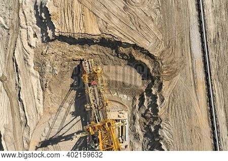 Aerial View Of Large Heavy Equipment Machine Mining Natural Resource. Coal Mining By Bucket Wheel Ex