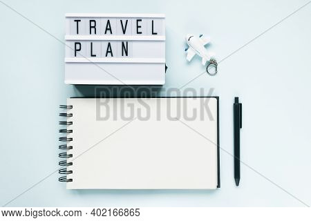 Open Notepad, Airplane, Pen And Text Travel Plan On Blue Background. Travelling To Do List, Vacation