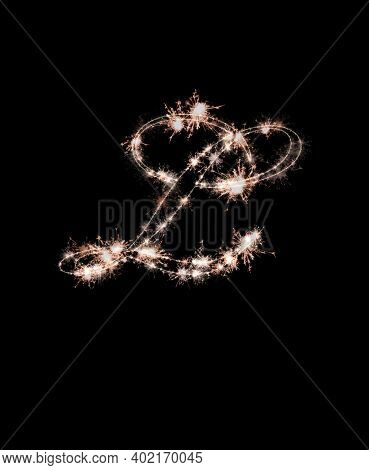 The Letter L Made From Sparks Of Bengal Lights Isolated On A Black Background. Beautiful Letters.