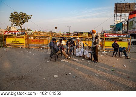 New Delhi, India - December 2020:
A Group Of Farmer Reading News Paper During The Protest. They Are 