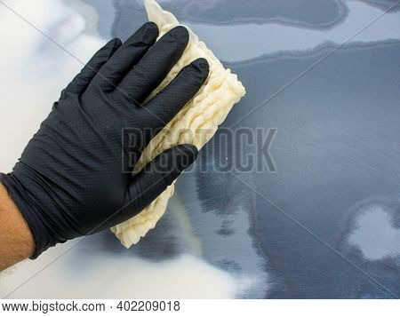 The Hand Of The Auto-painter In A Black Glove Holds A Special Napkin For Dusting The Surface Of The 