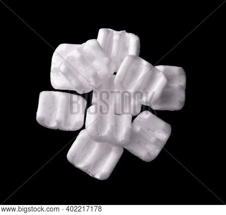 Top view of of m-shaped styrofoam packing chips isolated on black