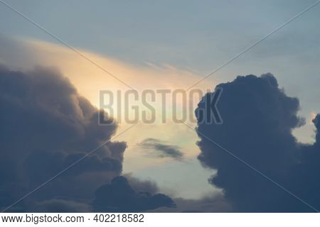 Iridescent Pileus Cloud Or Rainbow Sky With White Fluffy Clouds At Sunset In The Evening. Abstract N