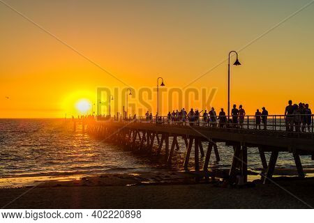 Adelaide, South Australia - March 18, 2017: Crowds Of People Walking Along Glenelg Beach Jetty At Su