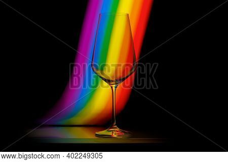 Photo Of Empty Wine Glass With Light Painting Background. It's Colors Of Rainbow And It Was Made Wit