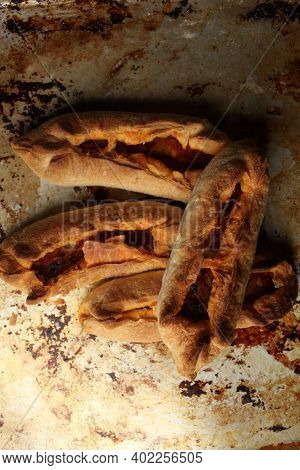 Twisted Pastry Stuffed With Cabbage On The Table. Russian Open Pirozhki, Baked Patties Stuffed With 