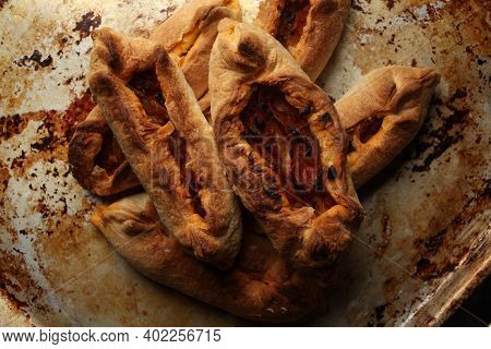 Twisted Pastry Stuffed With Cabbage On The Table. Russian Open Pirozhki, Baked Patties Stuffed With 