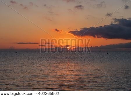 Sunrise With The Red Orange Sun Raising Up From The Sea With Dark Clouds At Beach Spiaggia Di Santa 