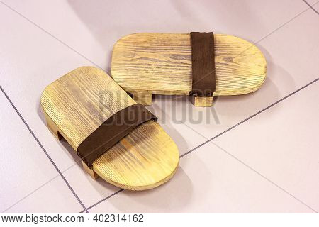 Traditional Japanese Wooden Footwear Geta On Light Floor Background.