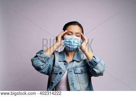 Asian Woman Wearing Protective Face Mask Was Sick With Headache Isolated Over White Background..