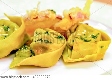 Italian Housewife With Traditional Manual Sheeter Rolls Egg Pasta, The Color Of The Sun Of Italy, Ma