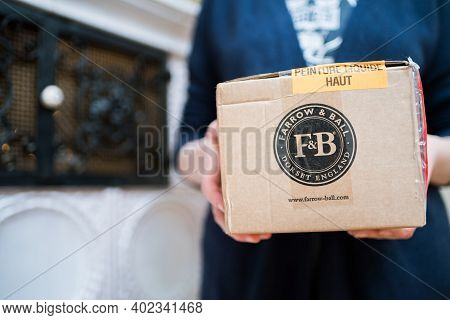 Paris, France - Dec 13, 2020: Woman Holding Parcel Package With Farrow And Ball Dorset England Luxur
