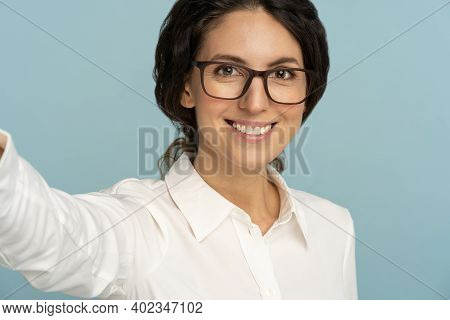 Happy Woman Having Cheerful Expression, Posing Over Studio Blue Background. Business Female Wearing 