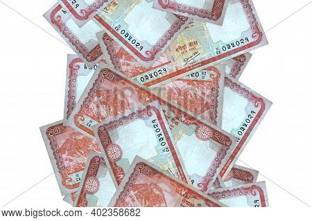 20 Nepalese Rupees Bills Flying Down Isolated On White. Many Banknotes Falling With White Copy Space