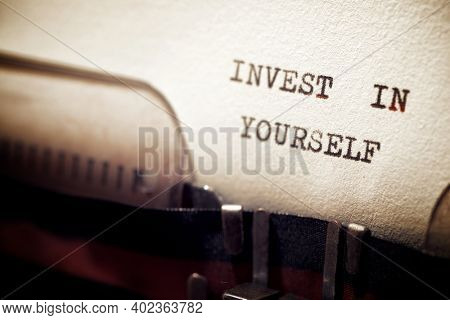 Invest in yourself phrase written with a typewriter.