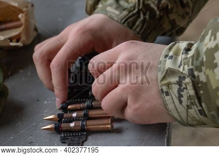 A Soldier Operator Equips A Machine-gun Belt With Live Ammunition For The Kalashnikov Machine Gun. S