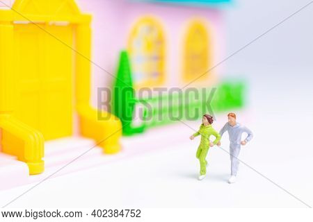 Miniature People , Couple Running Near Their House Together