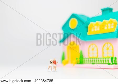 Miniature People , Couple Running Near Their House Together