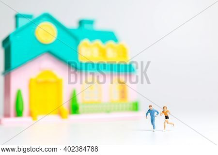 Miniature People , Couple Running Near Their House Together