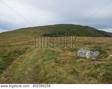 Footpath Of Hiking Trail From Chopok At Mountain Meadow, Grassy Hill Slopes With Thick Fog And Cloud