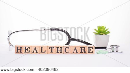 Healthcare Concept. Panoramic Banner Close Up Photo Of Stethoscope Pills And Wooden Blocks Making Sh