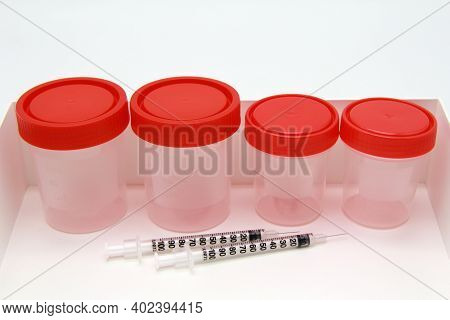 Plastic Medical Containers With Red Lids, Arranged In Rows And Syringes.concept Of Medical Research,