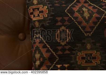 Vintage Woven Pillow With An Ornament On A Leather Sofa In The Hall Of A Restaurant Or Hotel.