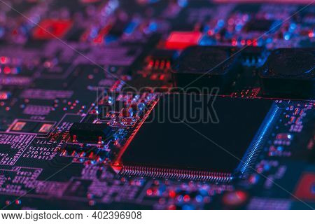Hardware Technology Concept In Neon Light. Motherboard In Blue-red Light. Computer  Component. Dark 